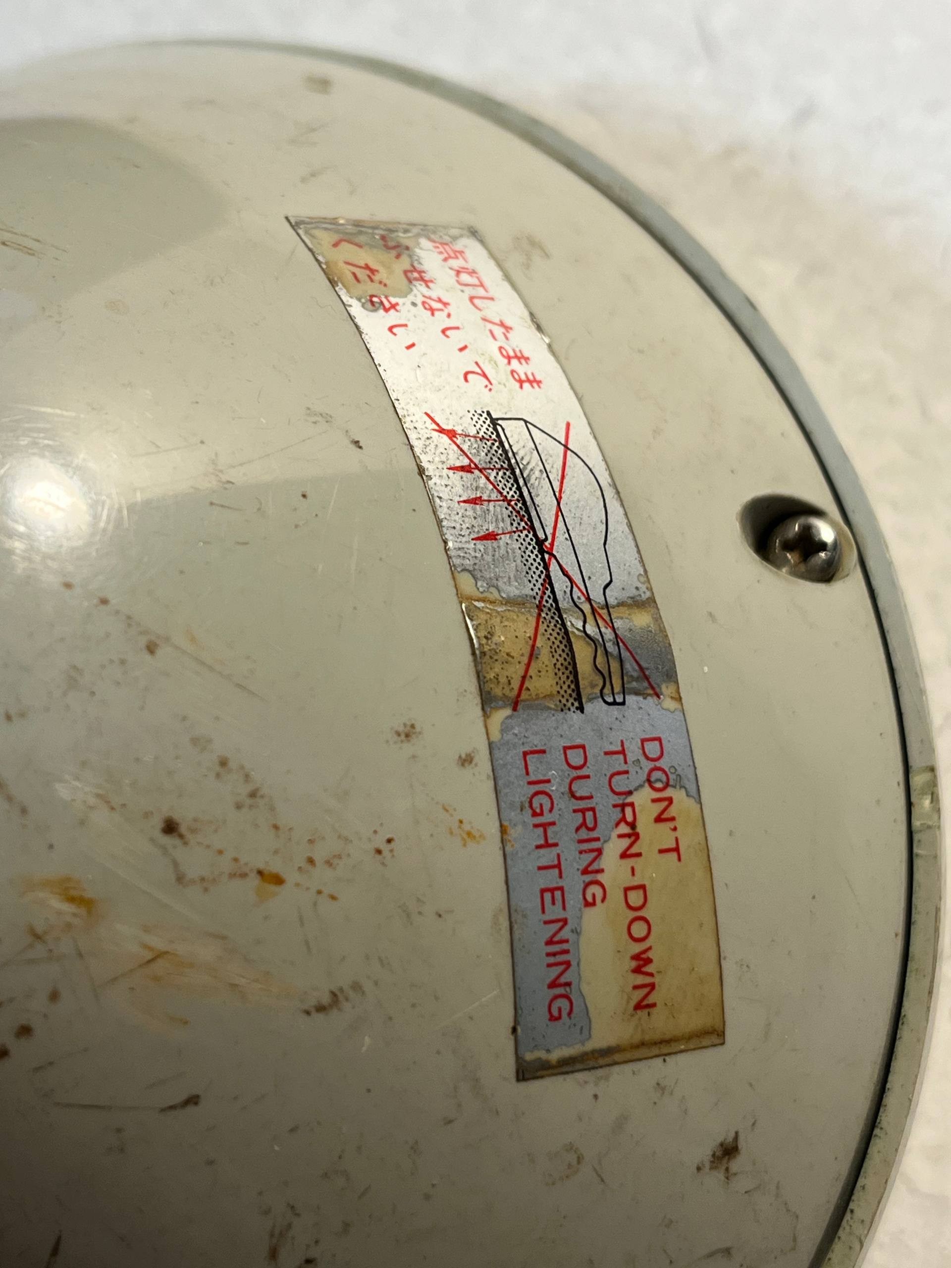 The backside of the torch, showing that one should not have it switched on while facing down.